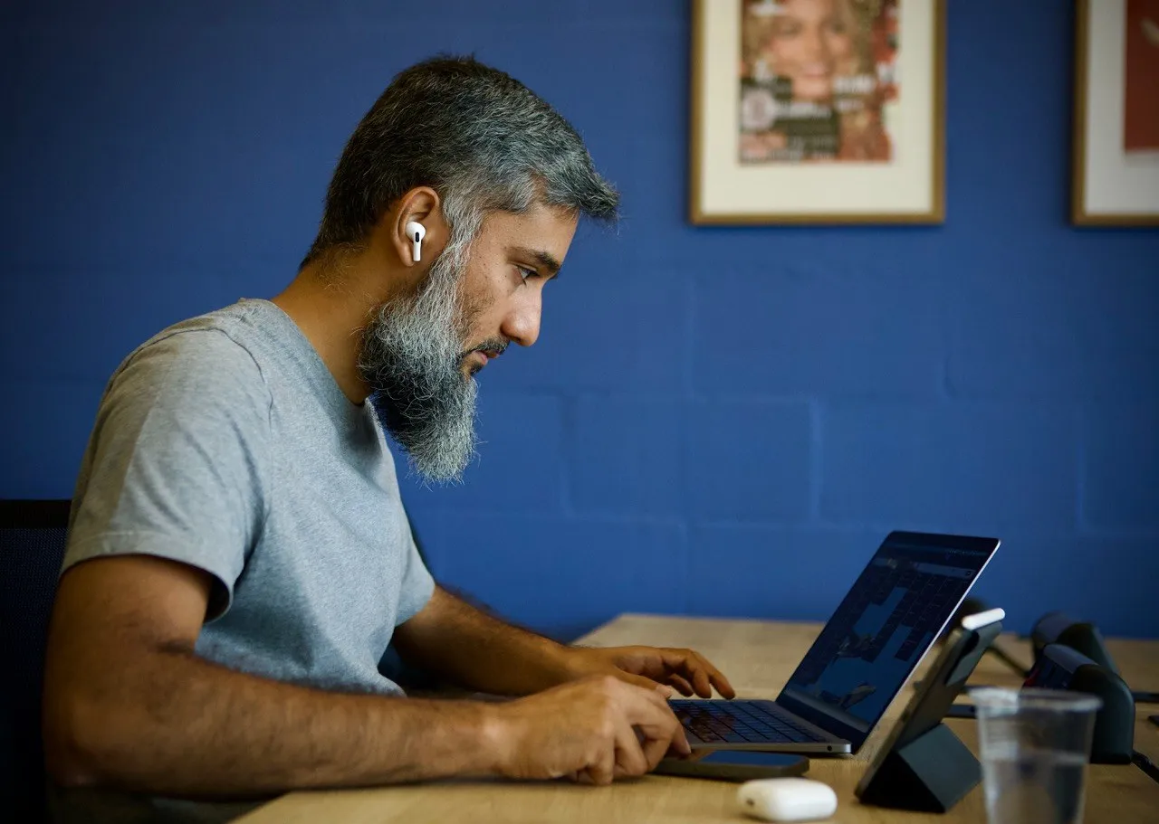 A Studio member working at his desk